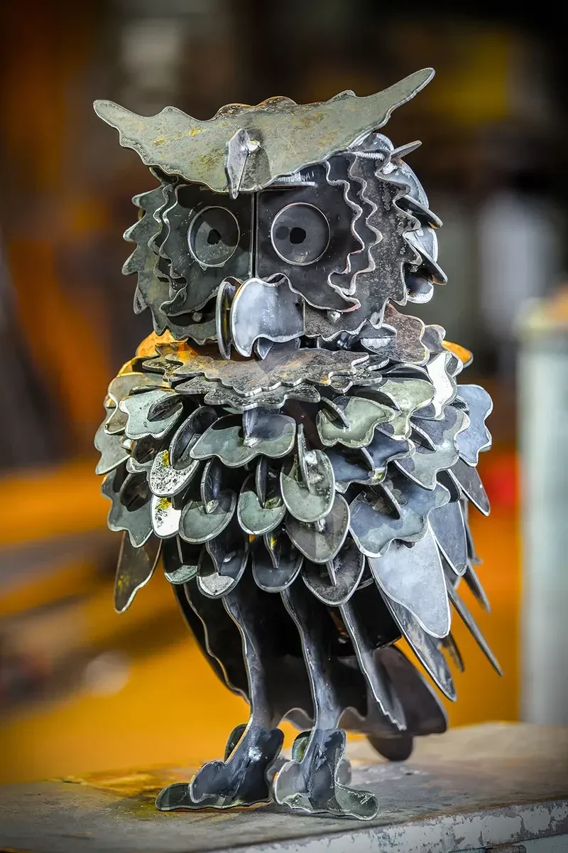 Freestanding owl sculpture assembled from many shaped steel pieces
