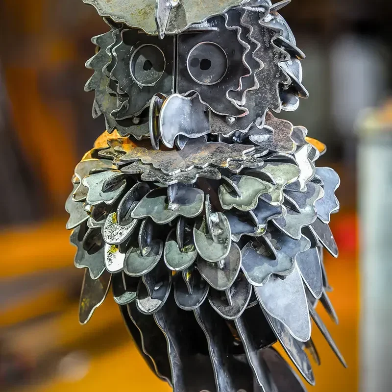 Freestanding owl sculpture assembled from many shaped steel pieces