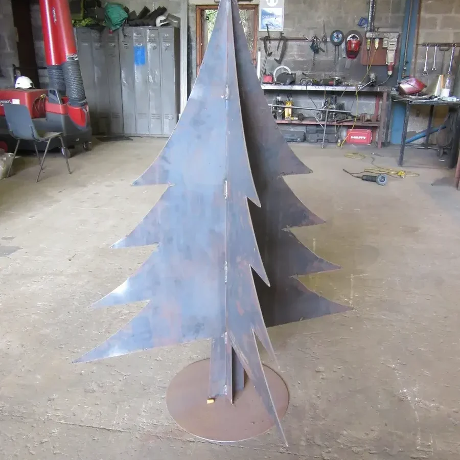 Freestanding stylised steel fir tree on a circular base