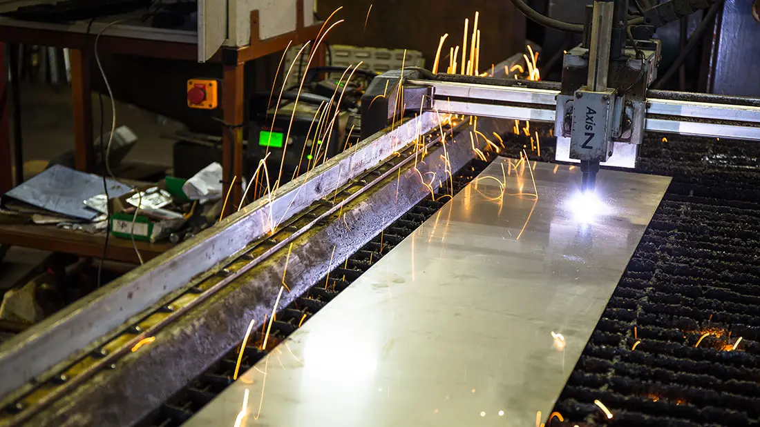 CNC plasma torch cutting a metal plate in the Peter Mitchell and Son workshop